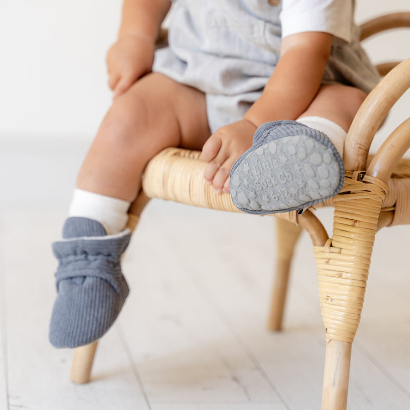 baby with stay on socks and booties on